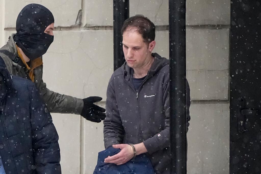 Wall Street Journal reporter Evan Gershkovich being escorted from court in Moscow, Russia, reflecting tense US-Russia relations.