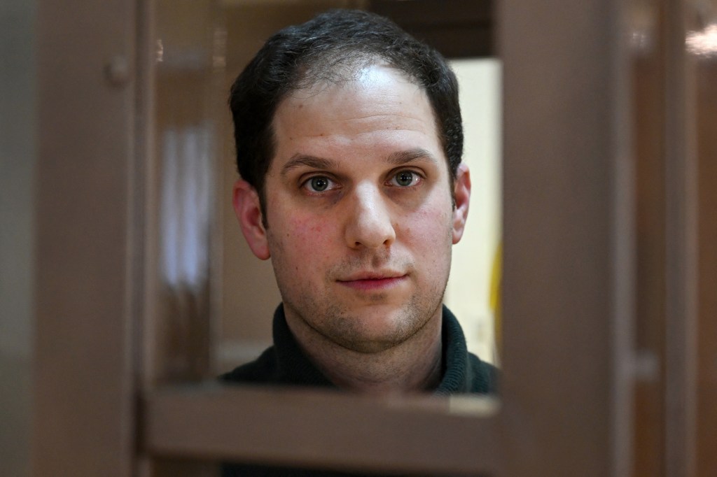 US journalist Evan Gershkovich looking out from inside a defendants' cage at Moscow City Court during a hearing related to his espionage charges