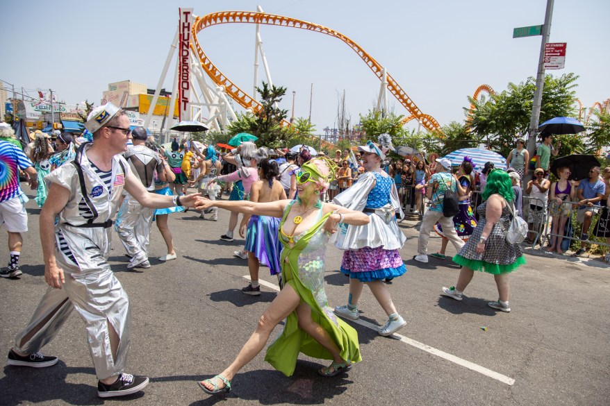 Participants dance in the street of the parade.