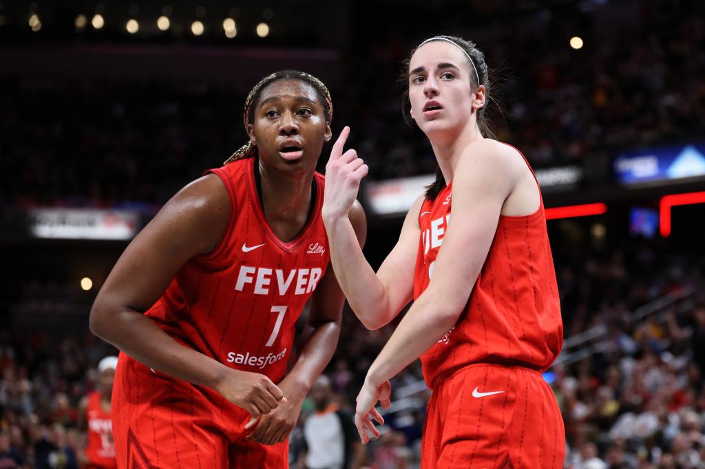 Caitlin Clark #22 of the Indiana Fever talks with Aliyah Boston #7 against the Chicago Sky during the fourth quarter in the game at Gainbridge Fieldhouse 