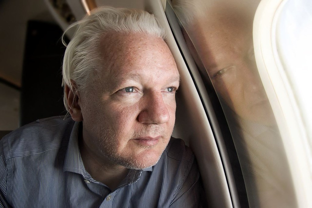 Assange looking out of the window as his plane from London approaches Bangkok for a layover at Don Mueang International Airport in the Thai capital.