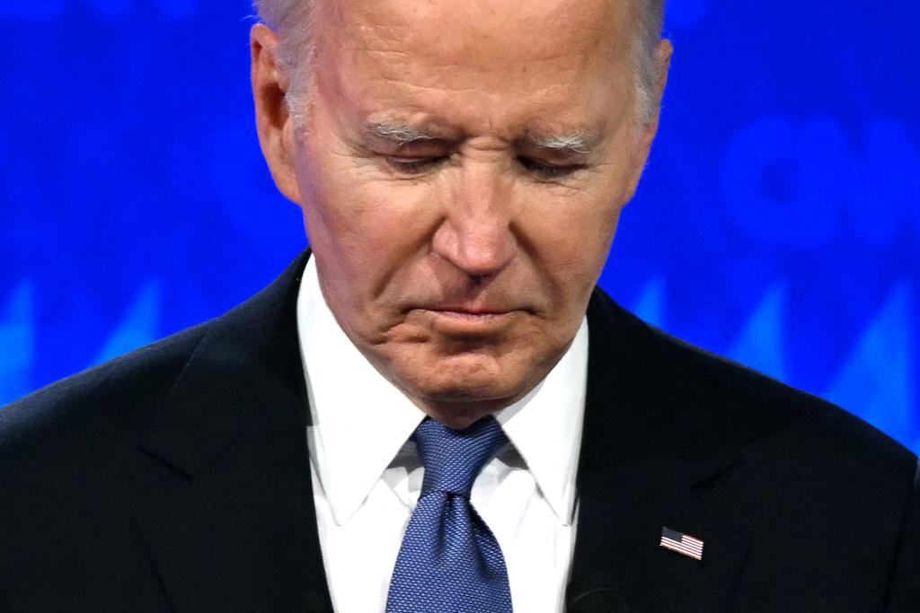 US President Joe Biden looks down as he participates in the first presidential debate of the 2024 elections with former US President and Republican presidential candidate Donald Trump.