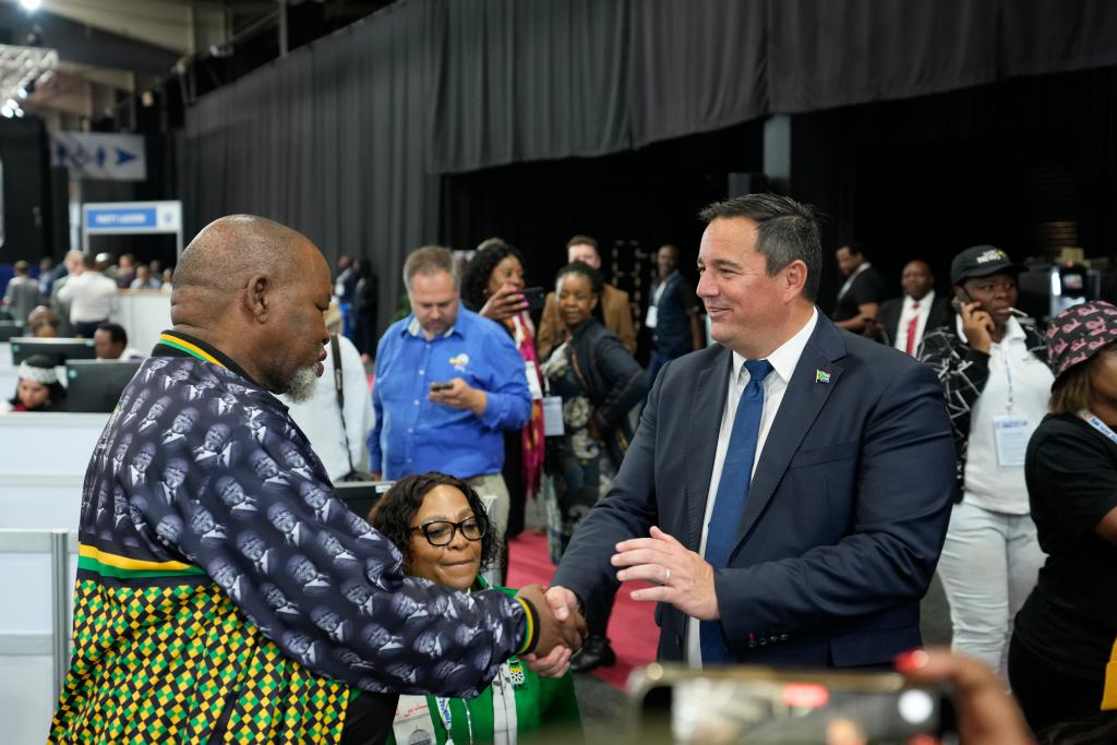 Leader of the main opposition Democratic Alliance John Steenhuisen, right, shakes hands with ANC's Chairman, Gwede Mantashe.