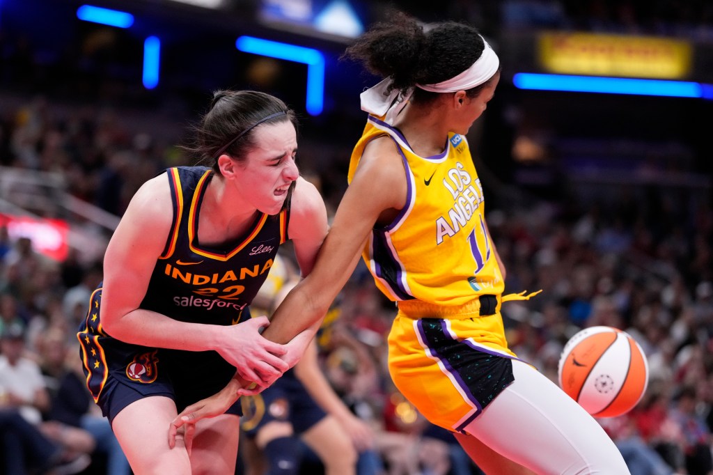 Indiana Fever guard Caitlin Clark (22) is fouled by Los Angeles Sparks guard Rae Burrell (12) in the second half of a WNBA basketball game in Indianapolis, Tuesday, May 28, 2024. 