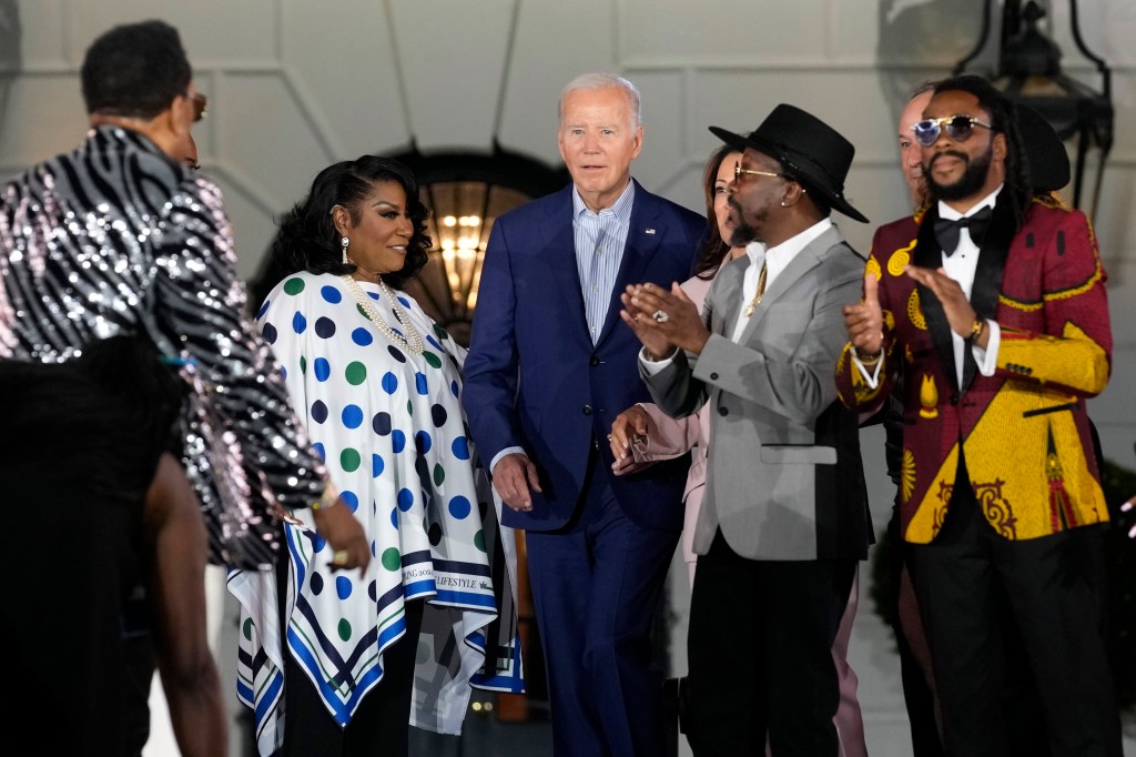 President Biden looks to singer and songwriter Charlie Wilson, left, as he stands with Patti LaBelle, Anthony Hamilton and Raheem DeVaughn, right, during a Juneteenth concert on the South Lawn of the White House in Washington, Monday, June 10, 2024. 