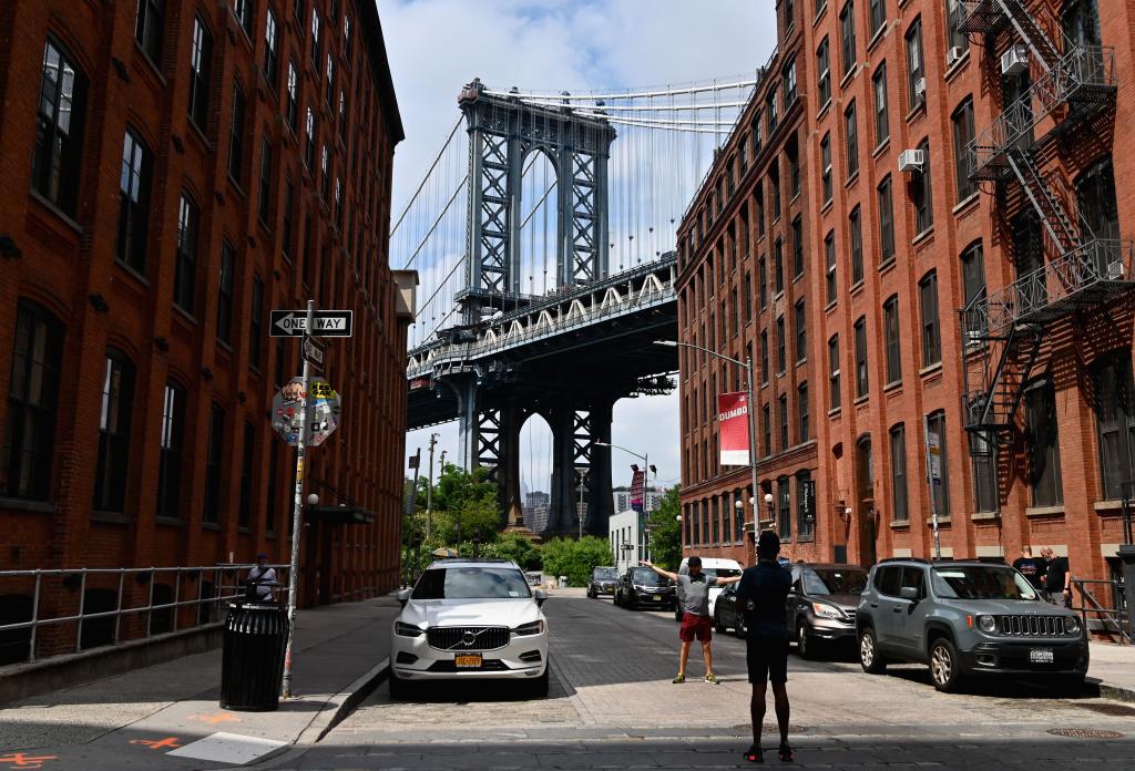 People taking pictures near the Manhattan Bridge in the DUMBO neighborhood of New York City during the coronavirus pandemic.