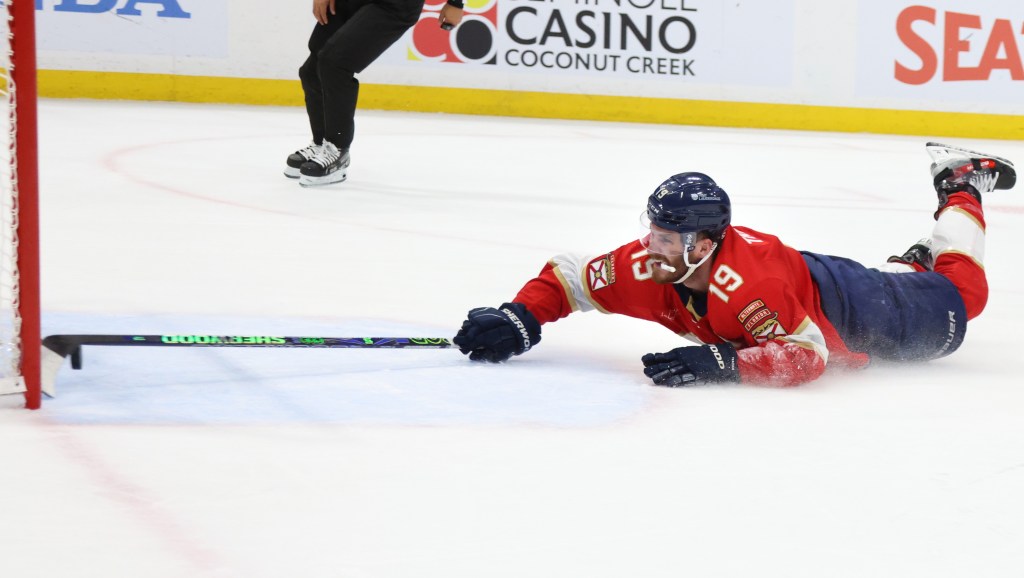 Matthew Tkachuk swipes the puck away from the net to prevent the Oilers from scoring an empty net goal, but it only delayed the inevitable as Connor McDavid gained control of the puck and scored the final goal a few seconds later.