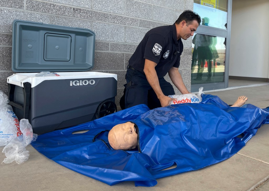 Phoenix Fire Capt. John Prato demonstrates a new protocol that the fire department in Americaâs hottest big city is adopting as the West braces for the first heat wave of the summer season, Monday, June 3, 2024, in Phoenix.