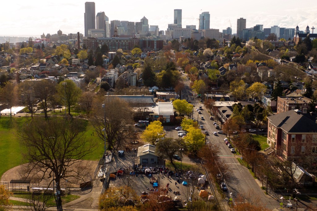 In an aerial photograph taken with a drone, a group of mostly Venezuelan migrants camp on the tennis courts of a community center after losing access to other shelter in Seattle, Washington , U.S. April 3, 2024.