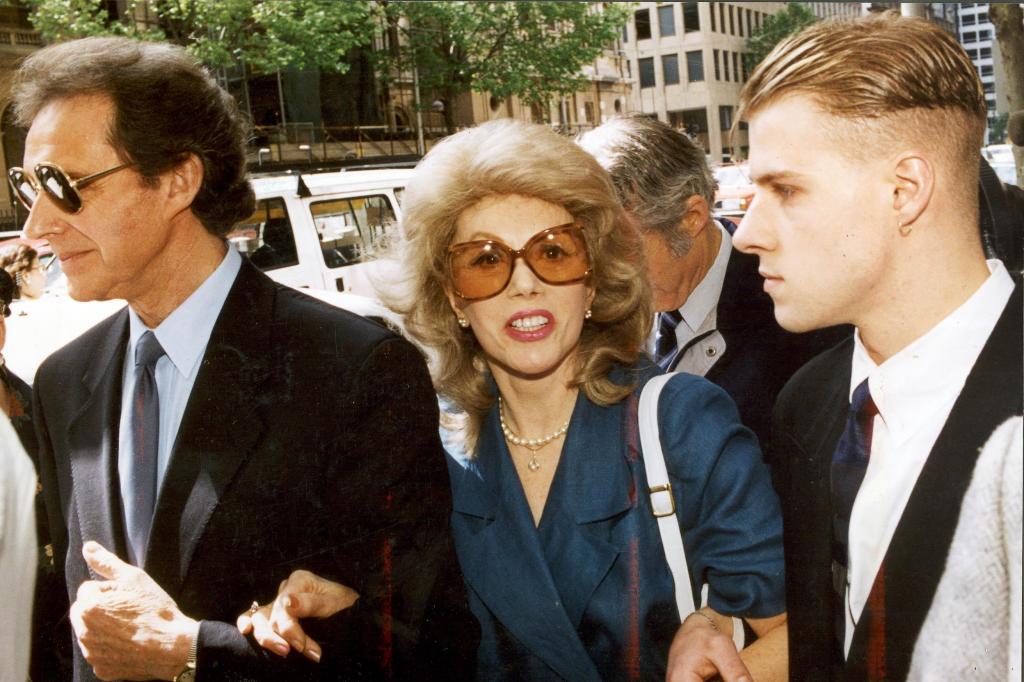 Anne Hamilton Byrne in a blue suit and sunglasses, alongside her husband William and a friend, arriving at the County Court in Melbourne on 15 November 1993