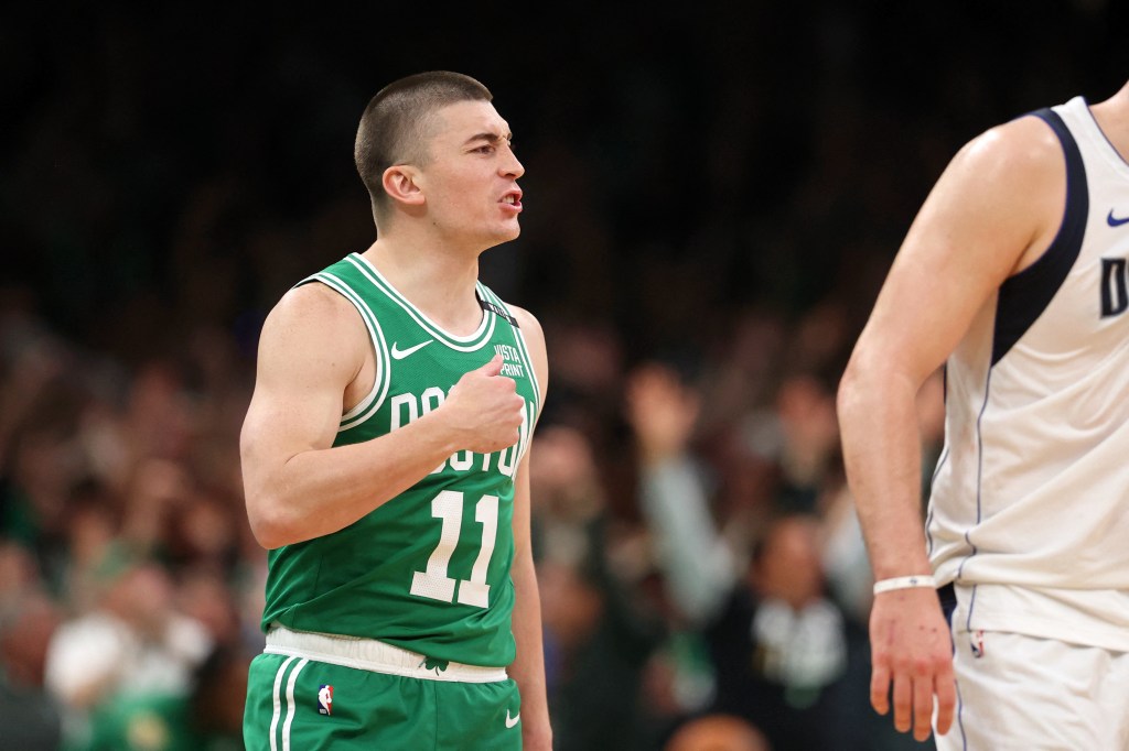 Celtics guard Payton Pritchard (11) reacts after making a half-court shot at the buzzer to end the second quarter in Game 5. 