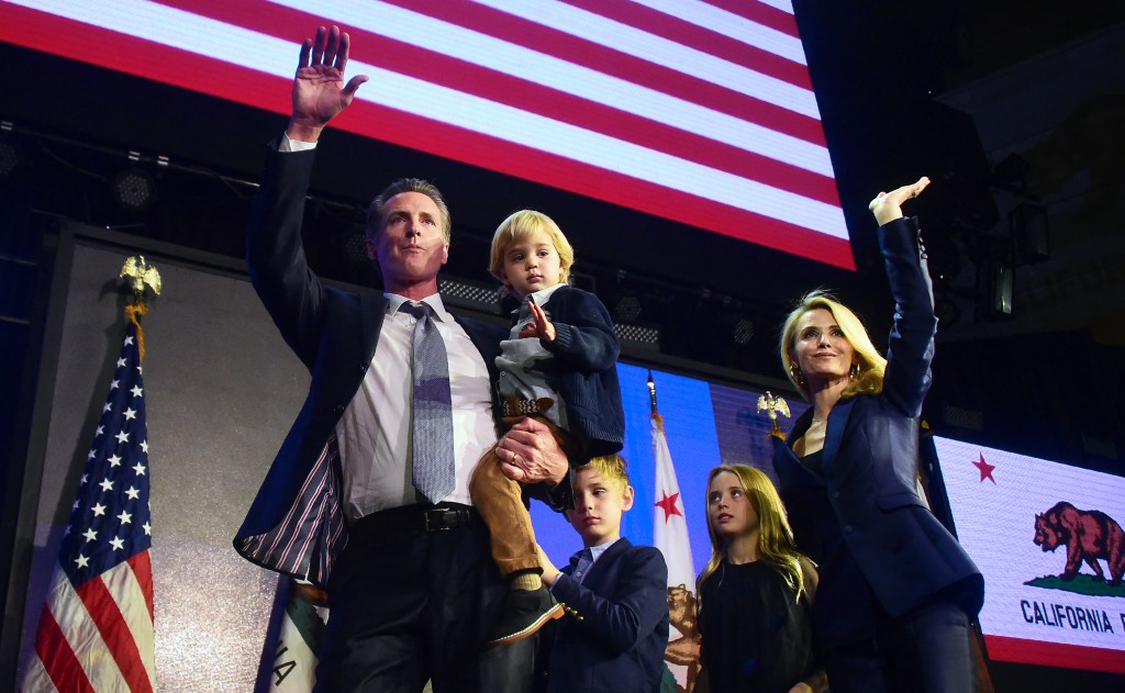  California's Democratic gubernatorial candidate Gavin Newsom and his family waves to supporters from stage at his election night watch party in Los Angeles, California on November 6, 2018.