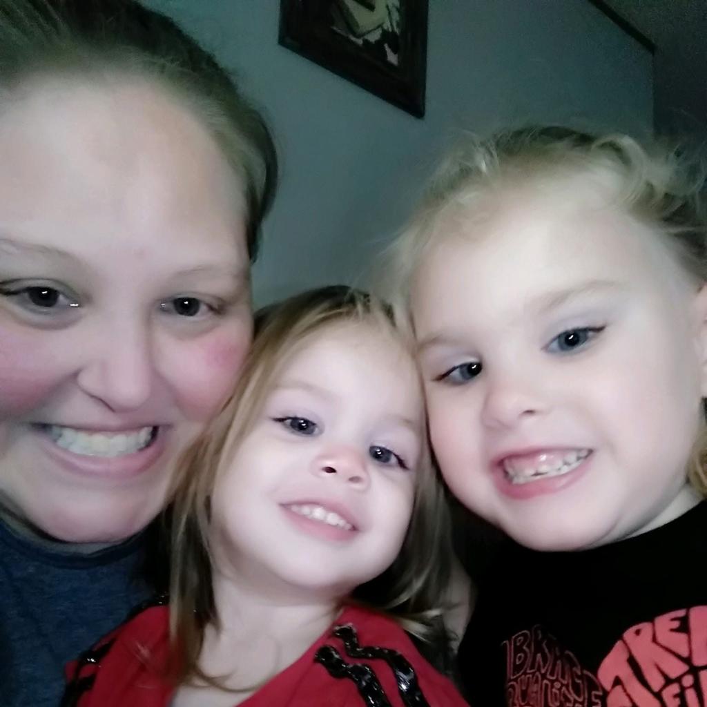 callie brunett smiling into the camera next to Erin, 4, and Jalie, 6