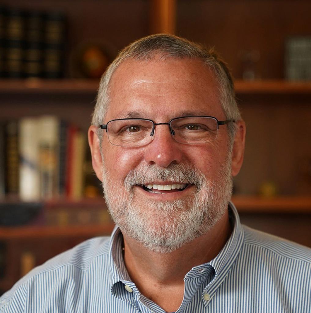 Chris Williams, former Vice President of Human Resources at Microsoft, wearing glasses and smiling