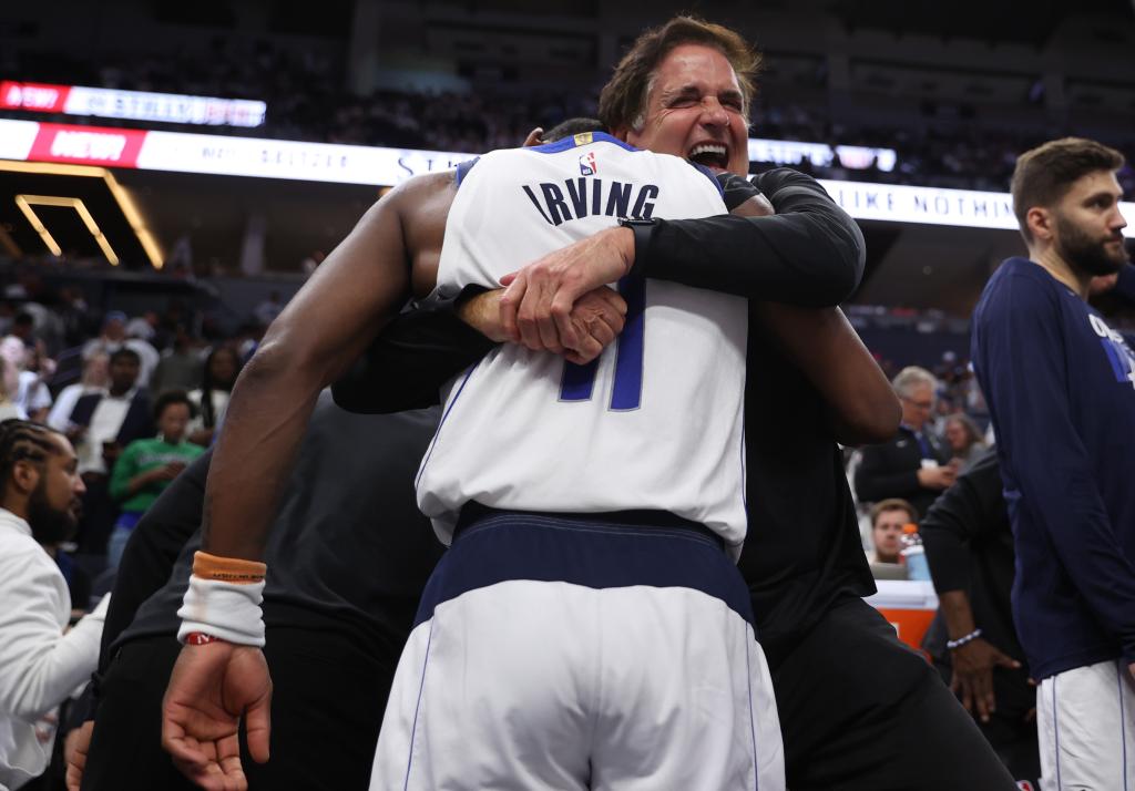 Dallas Mavericks minority owner Mark Cuban celebrates with guard Kyrie Irving (11) after winning the Western Confrerence Championship against the Minnesota Timberwolves in game five of the western conference finals for the 2024 NBA playoffs at Target Center.