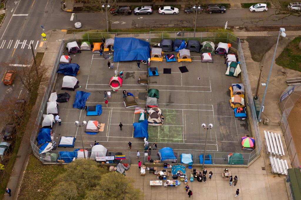 A drone view of a group of mostly Venezuelan migrants camp on the tennis courts of a community center after losing access to another shelter in Seattle, Washington, U.S. April 3, 2024.