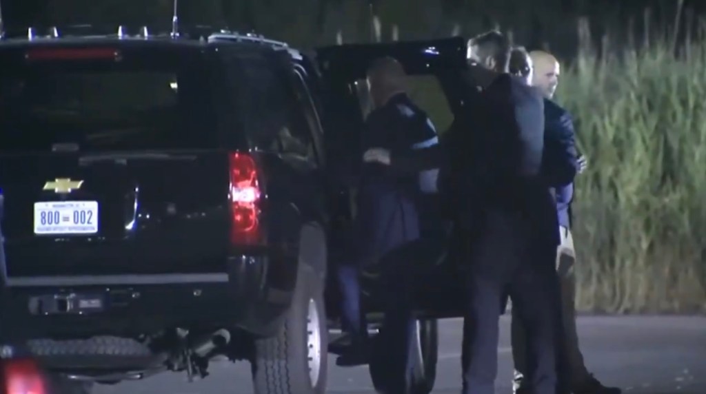 A group of people getting into a car near the White House