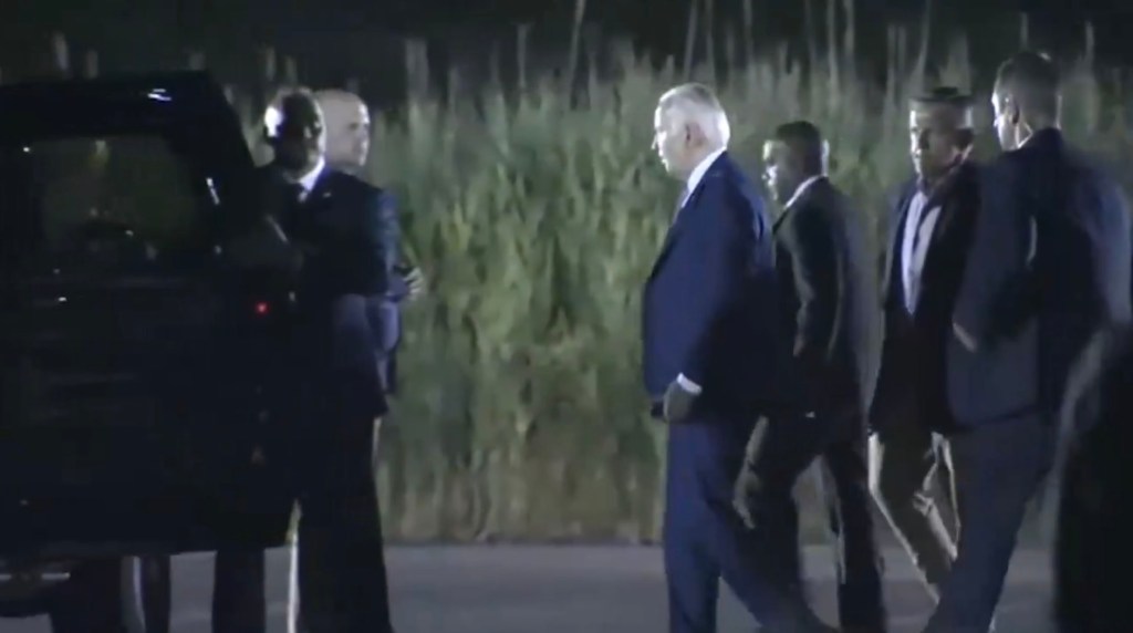 A group of men in suits walking, representing White House officials discussing viral videos during the upcoming general election season