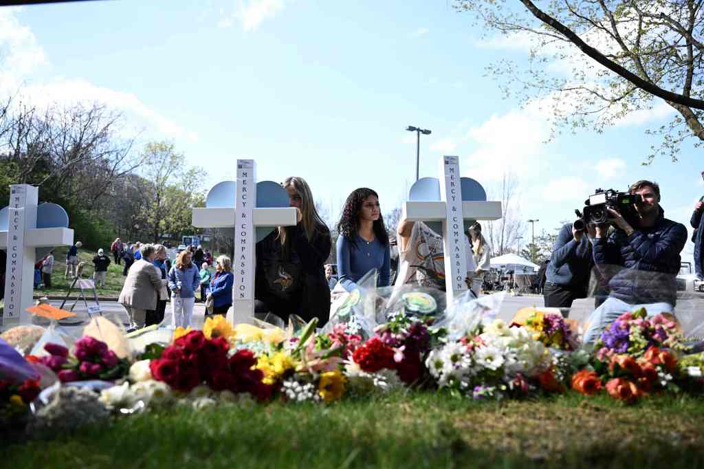 People pay their respects at a makeshift memorial for the victims of the shooting, at the Covenant Presbyterian Church in Nashville, Tennessee, on March 28, 2023.