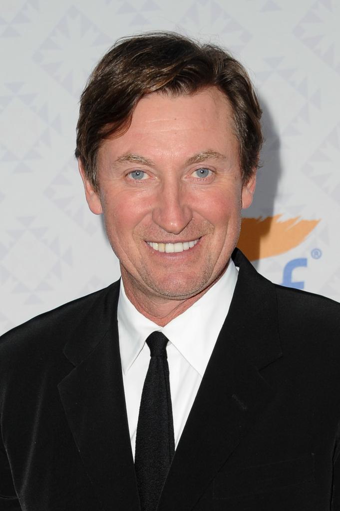 Wayne Gretzky from chest up. He wears a coat and tie. 