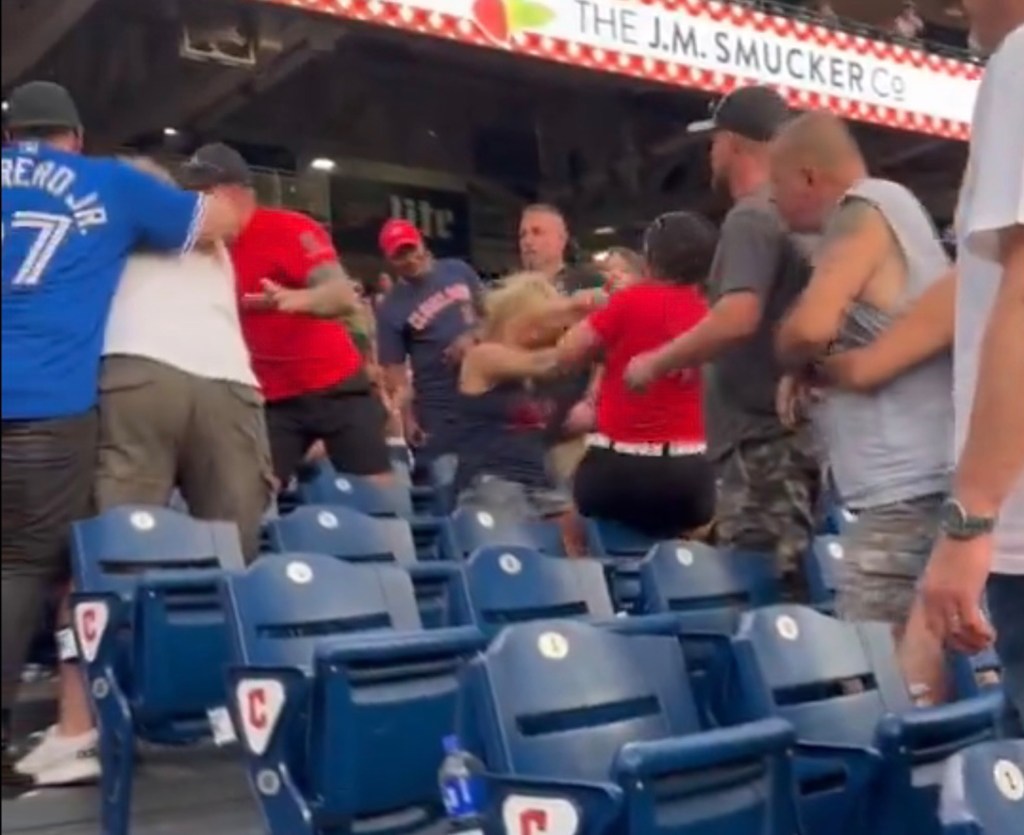 A group of people at a baseball stadium in downtown Cleveland for a Friday night event.