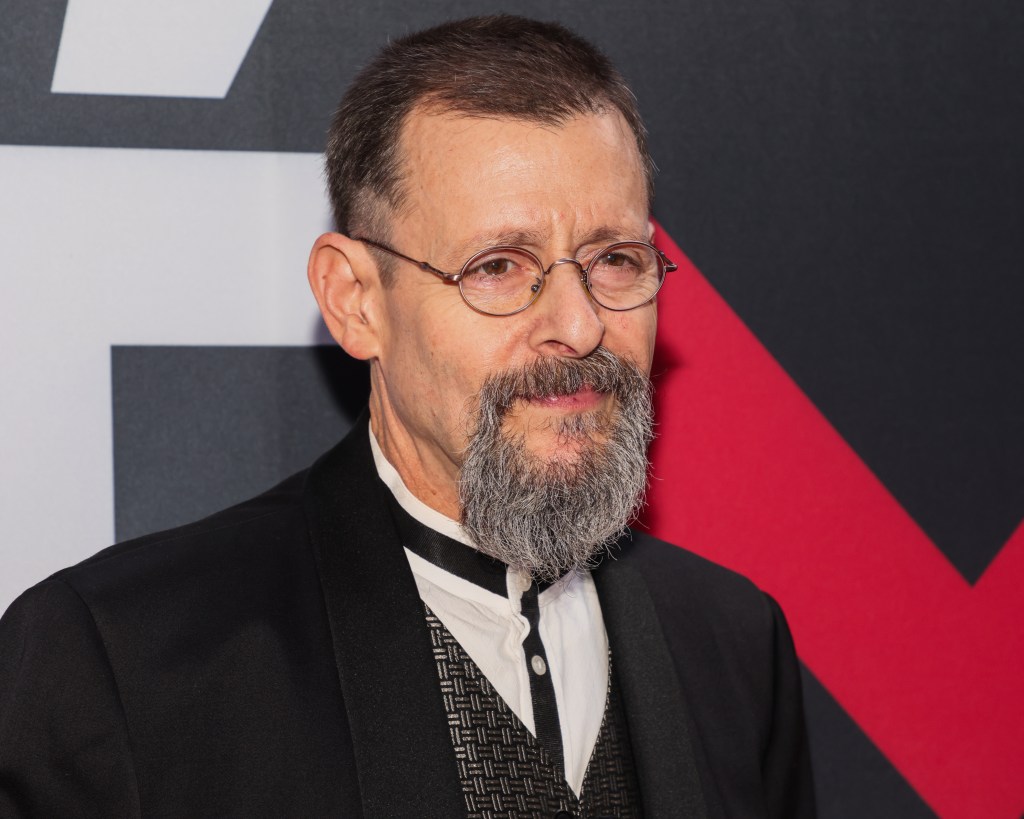 Judd Nelson, a bearded man with glasses, attending the 24th Annual Academy Awards Celebration for Justice For Women International and Children Uniting Nations in Beverly Hills, California