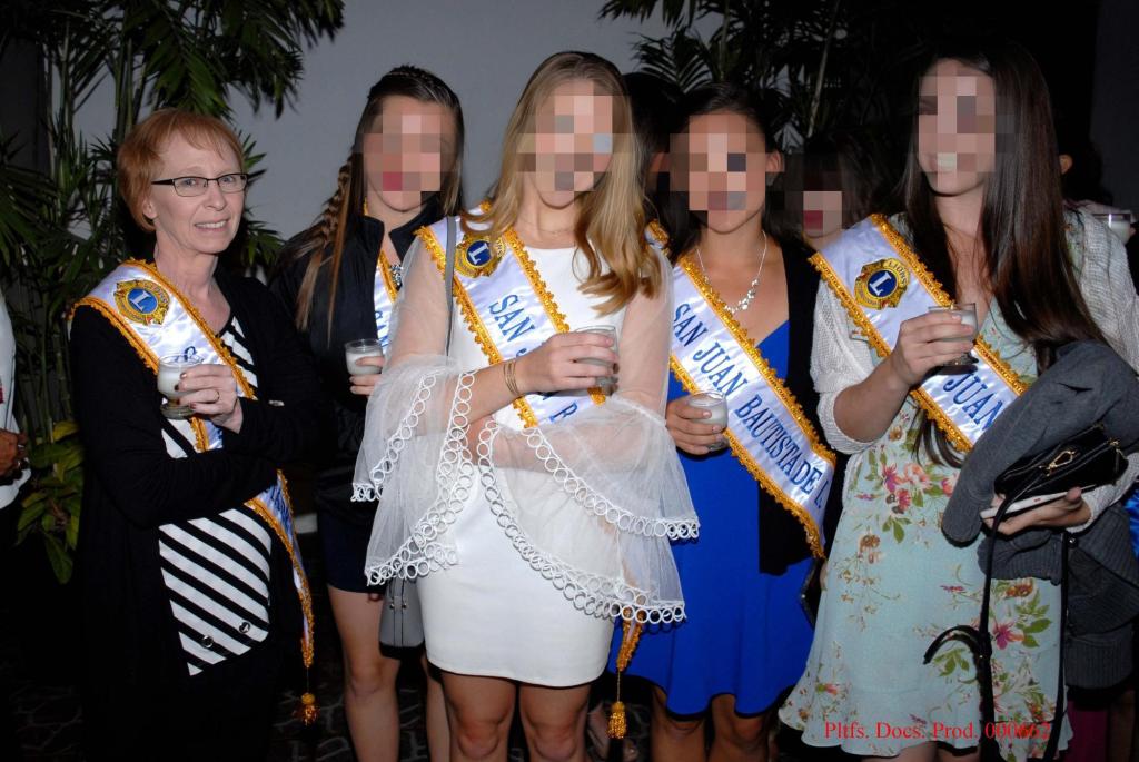 Slagle, far left, in a group shot with the teenage twirlers, whose faces are obscured