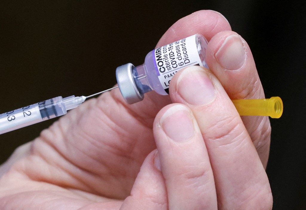 A medical staff preparing a booster dose of Pfizer's COVID-19 vaccine at a vaccination centre in Brussels, Belgium