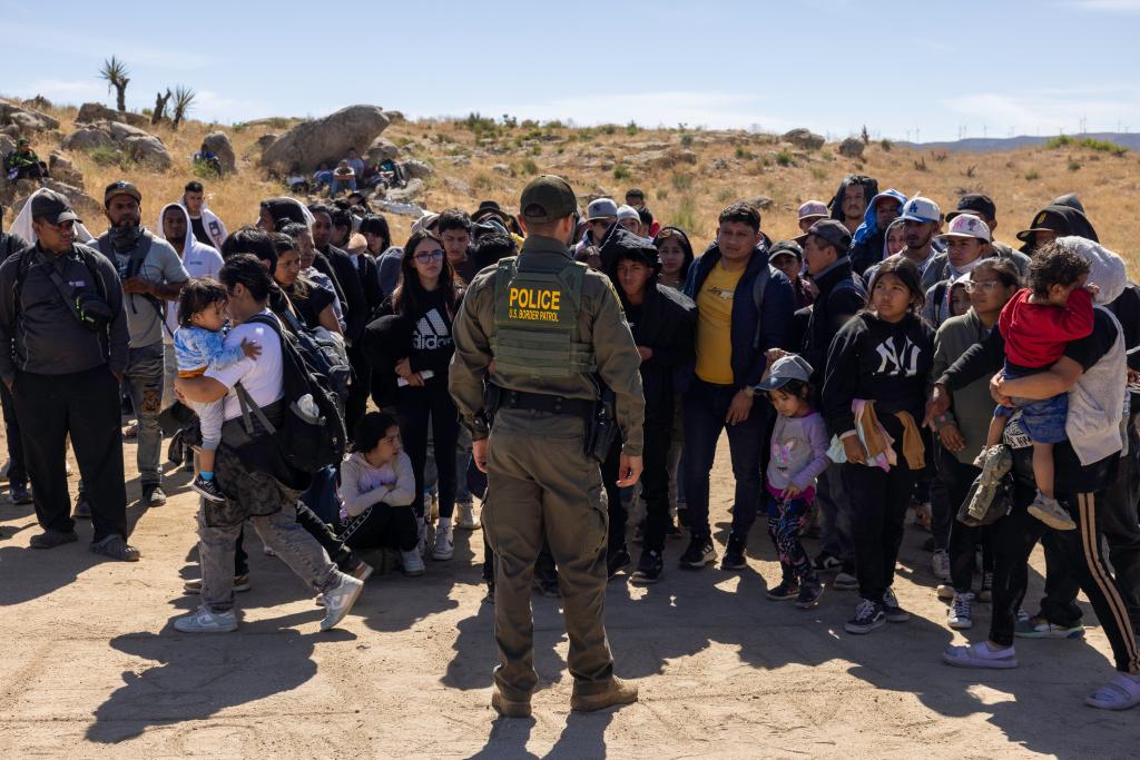 Migrants from around the world continue to arrive across the U.S. southern border near Jacumba Hot Springs, California. After crossing the border from Mexico migrants from countries including Sudan, Mauritania, India, China, Iran as well as many Latin American countries wait for Border Patrol to transport them for processing.