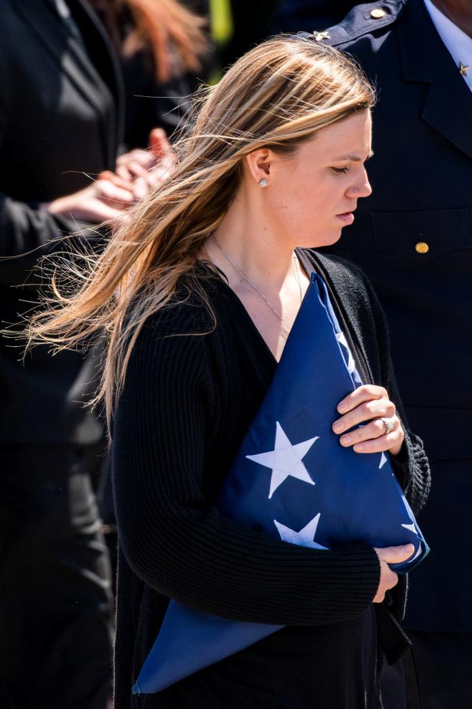 Stephanie Diller holds the flag that had been draped over her dead husband's casket.