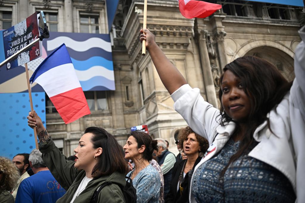 Protesters demonstrated in front of Paris City Hall while waving French flags.