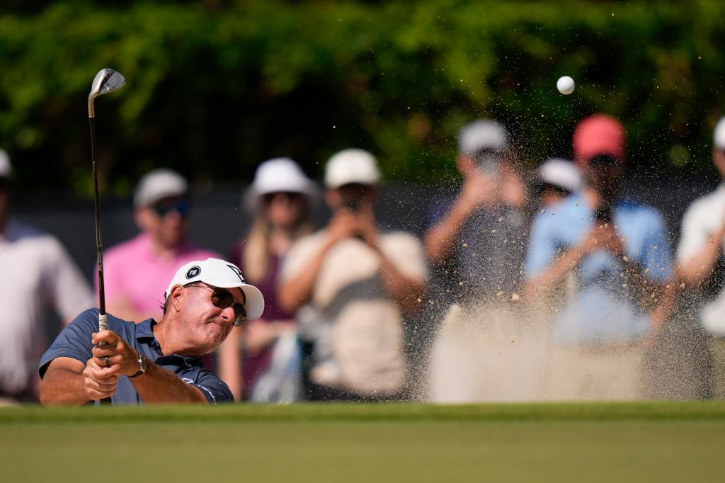 Phil Mickelson hits from the bunker on the ninth hole during the first round of the 2024 U.S. Open on Thursday.