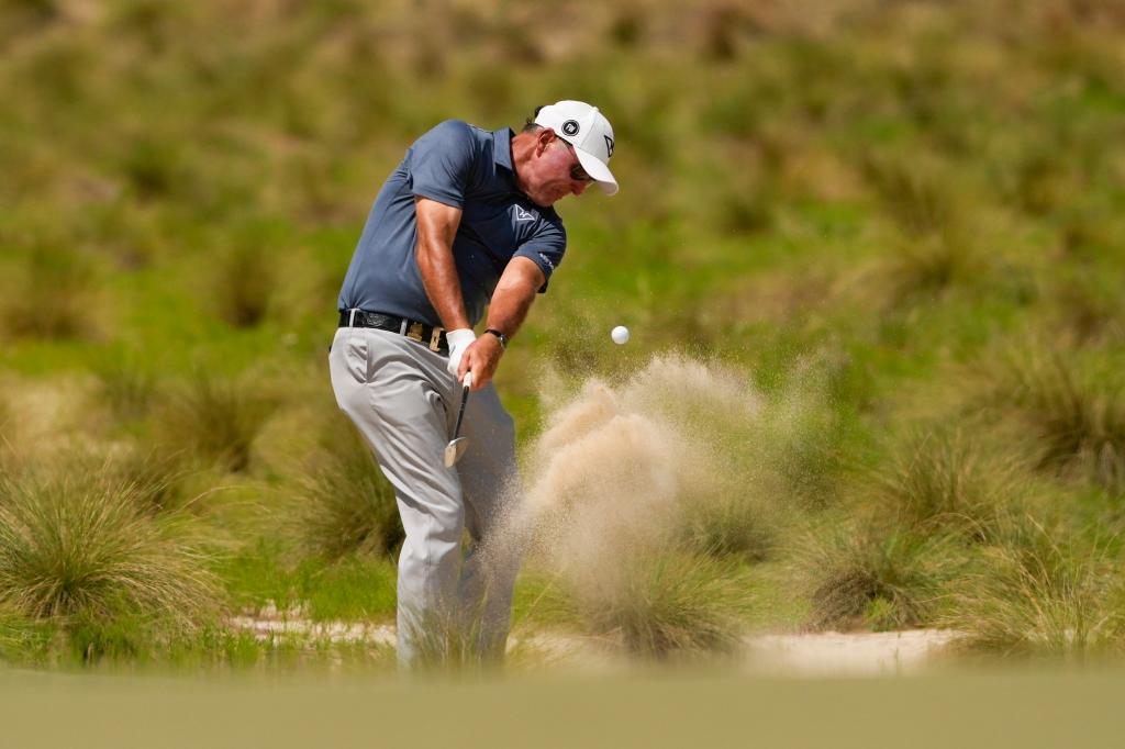 Phil Mickelson hits from the native area on the 12th hole during the first round of the 2024 U.S. Open on Thursday.