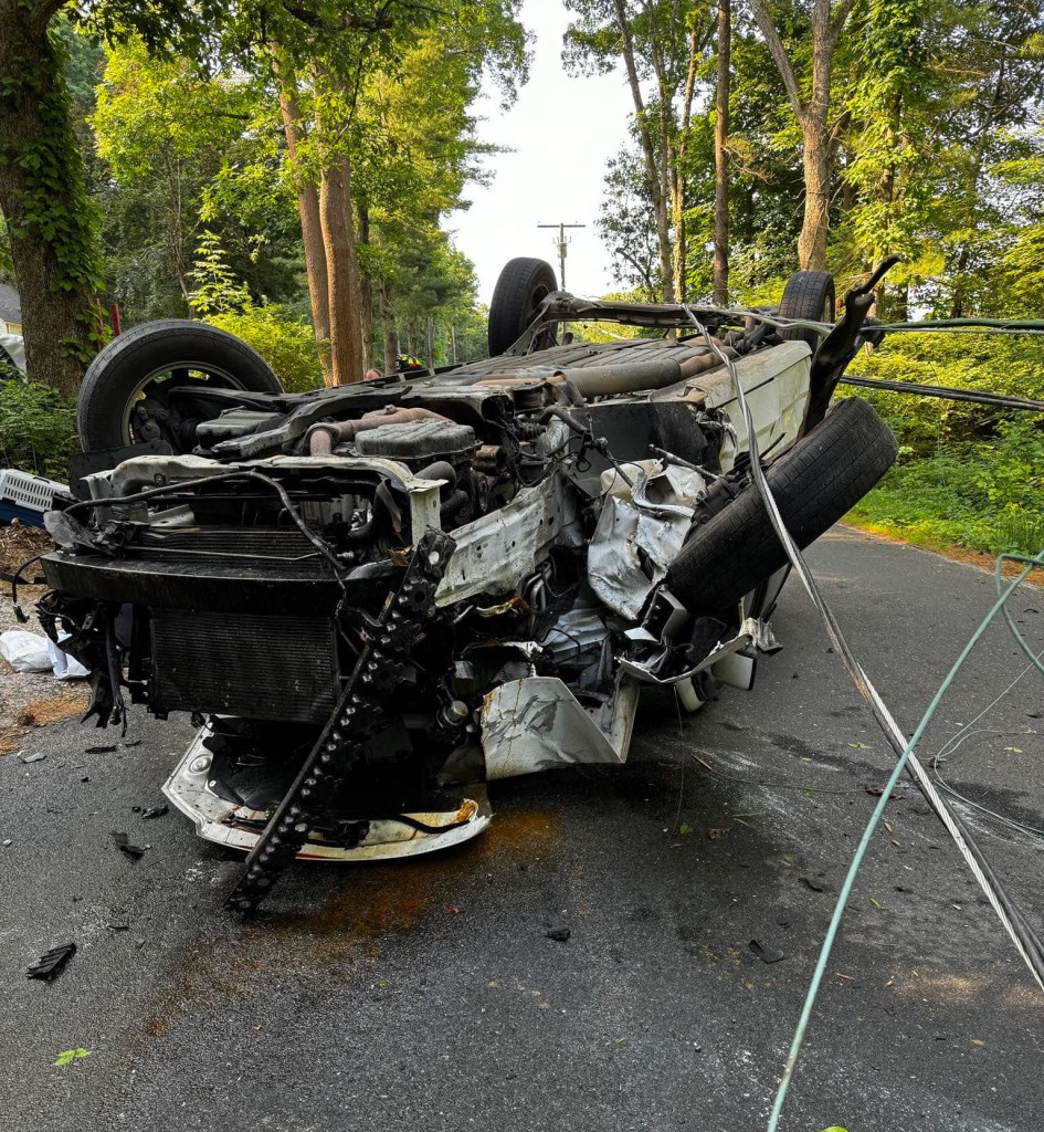 The vehicle hit a utility pole and overturned, police said.