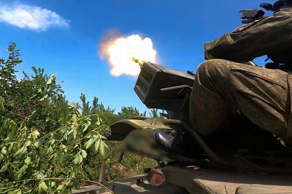 Russian soldiers in military uniform firing an anti-aircraft gun at an undisclosed location in Ukraine on June 21, 2024