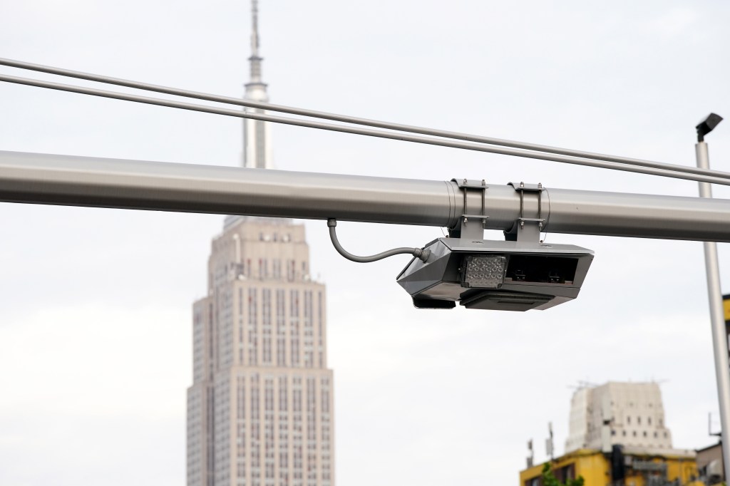 Congestion pricing toll gantry on W40th Street, New York with the Empire State Building in the background