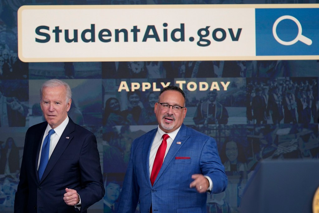 President Joe Biden answers questions with Education Secretary Miguel Cardona as they leave an event about the student debt relief portal beta test in the South Court Auditorium on the White House complex in Washington, Monday, Oct. 17, 2022.