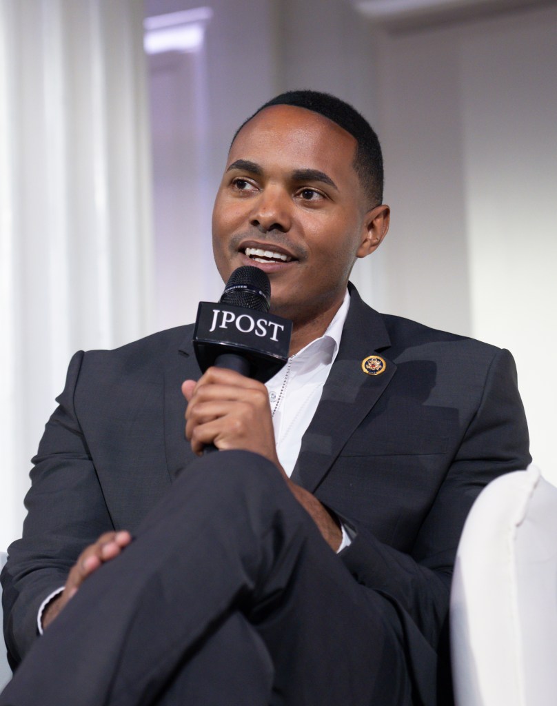 Rep. Ritchie Torres (D-NY) speaking at The Jerusalem Post New York conference on June 03, 2024, holding a microphone.