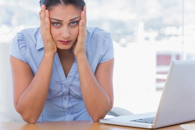 businesswoman having her head in hands