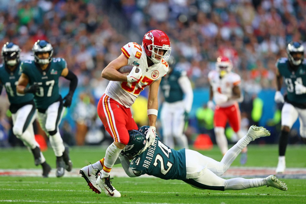 Kansas City Chiefs tight end Travis Kelce (87) runs with the ball against Philadelphia Eagles cornerback James Bradberry (24) during the first quarter of Super Bowl LVII at State Farm Stadium on Feb. 12, 2024. 