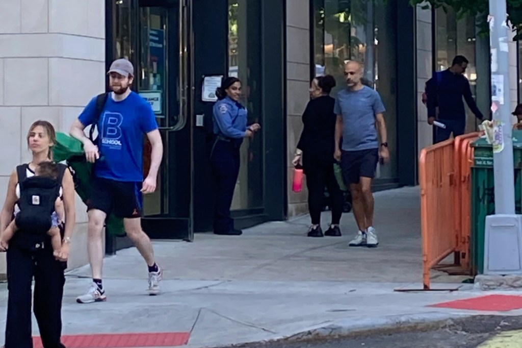 NYPD School Safety officer walking on a sidewalk outside the District 2 Pre-K Center in the Upper East Side