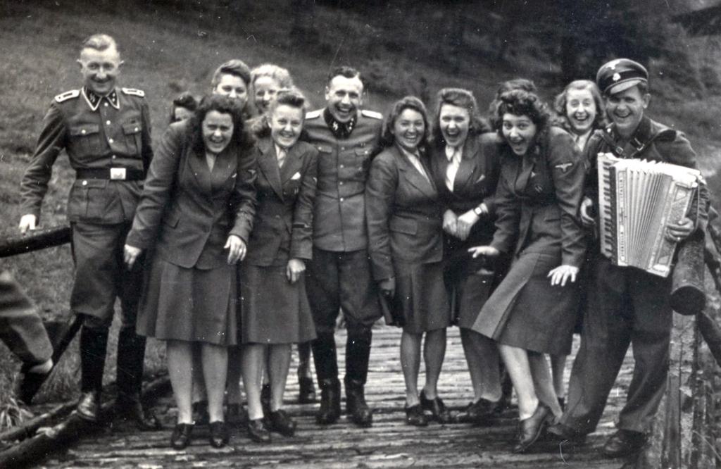 Uniformed women pose for a picture with a male Nazi at Solahütte, a little known SS resort some 30 km south of Auschwitz on the Sola River. A chilling photo album shows Nazis at Auschwitz enjoying blueberries and sunbathing in deckchairs. The candid moments were captured on camera as 1.1 million people were murdered at the death camp. The album was found by an unnamed American counterintelligence officer who was billeted in Frankfurt after Germany's surrender in 1945. The photos are now the subject of a play that opened last month off-broadway, the 2024 Pulitzer Prize for Drama finalist Here There Are Blueberries. The play dramatises the work of the curators who examined the mysterious album featuring the Nazi-era photographs that arrived at the desk of a U.S. Holocaust Memorial Museum (USHMM) archivist in 2007. The album consists of 116 photographs taken during the last six months of Auschwitz, between June 1944 and January 1945. The album shows Auschwitz during its most lethal period, coinciding with the murder of 400,000 Hungarian Jews.