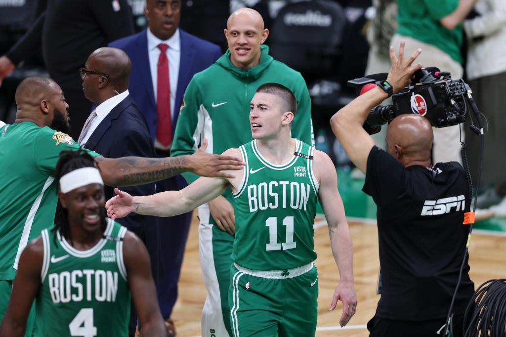Payton Pritchard #11 of the Boston Celtics reacts after making a half court shot at the buzzer against the Dallas Mavericks during the second quarter of Game Five of the 2024 NBA Finals at TD Garden on June 17, 2024 in Boston, Massachusetts.  
