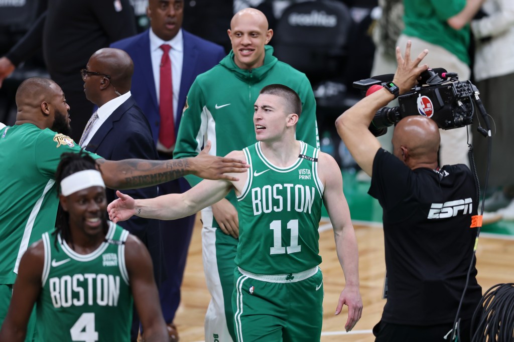 Payton Pritchard #11 of the Boston Celtics reacts after making a half court shot at the buzzer against the Dallas Mavericks during the second quarter of Game Five of the 2024 NBA Finals at TD Garden on June 17, 2024 in Boston, Massachusetts.  