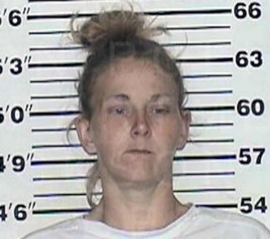 Victoria Cox, 32, a woman in a white shirt, arrested by Jackson Police as a possible accomplice to Daniel Callihan