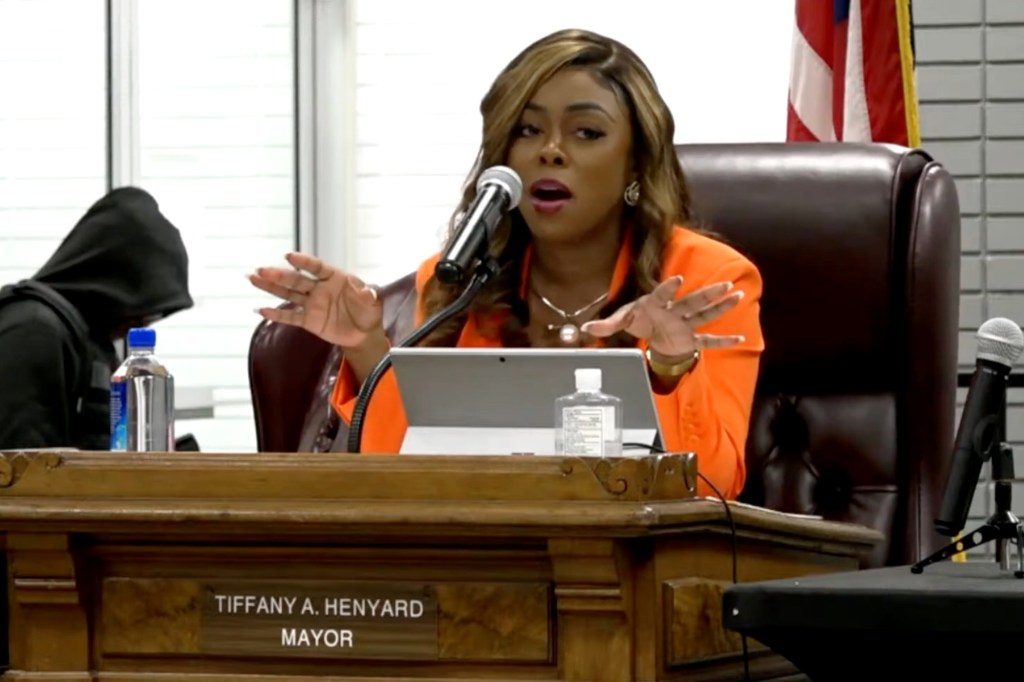 A woman delivering a speech at a contentious village meeting in Dolton