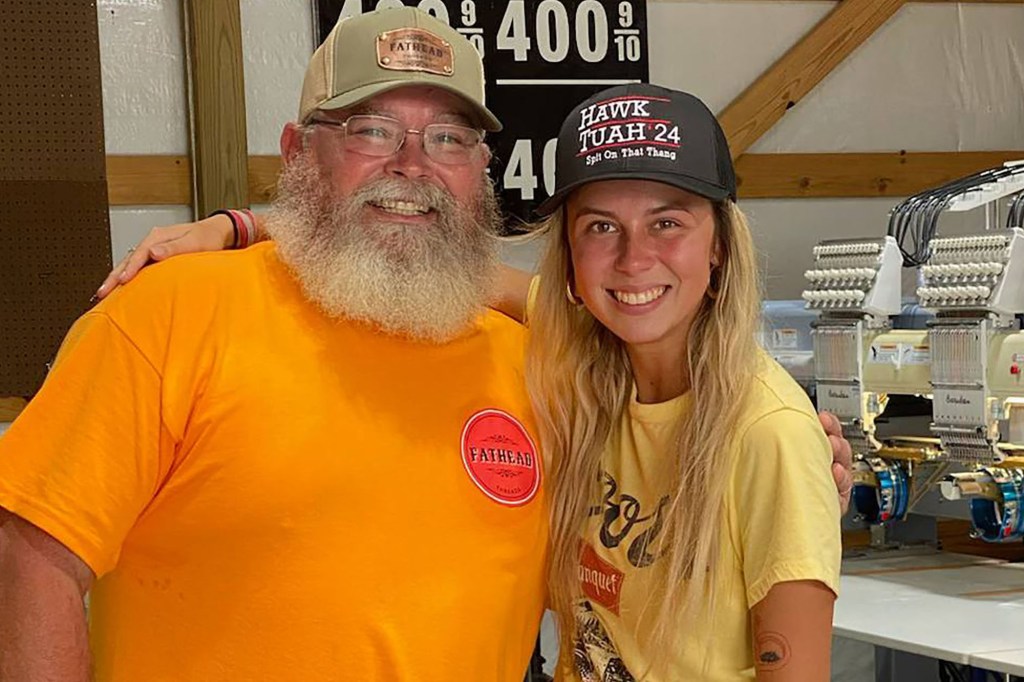 Welch posing in one of the official Hawk Tuah Girl hats with Fathead founder Jason Poteete.