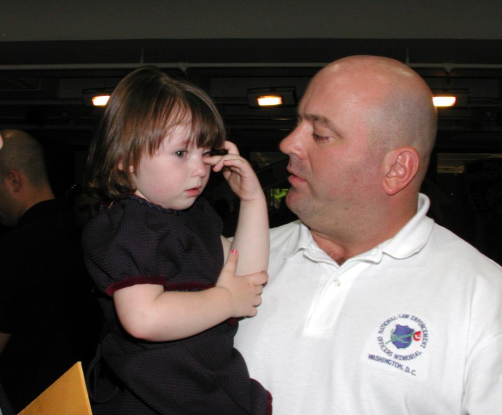 James Smith husband of PO Moira Smith, comforts their daughter, Patricia