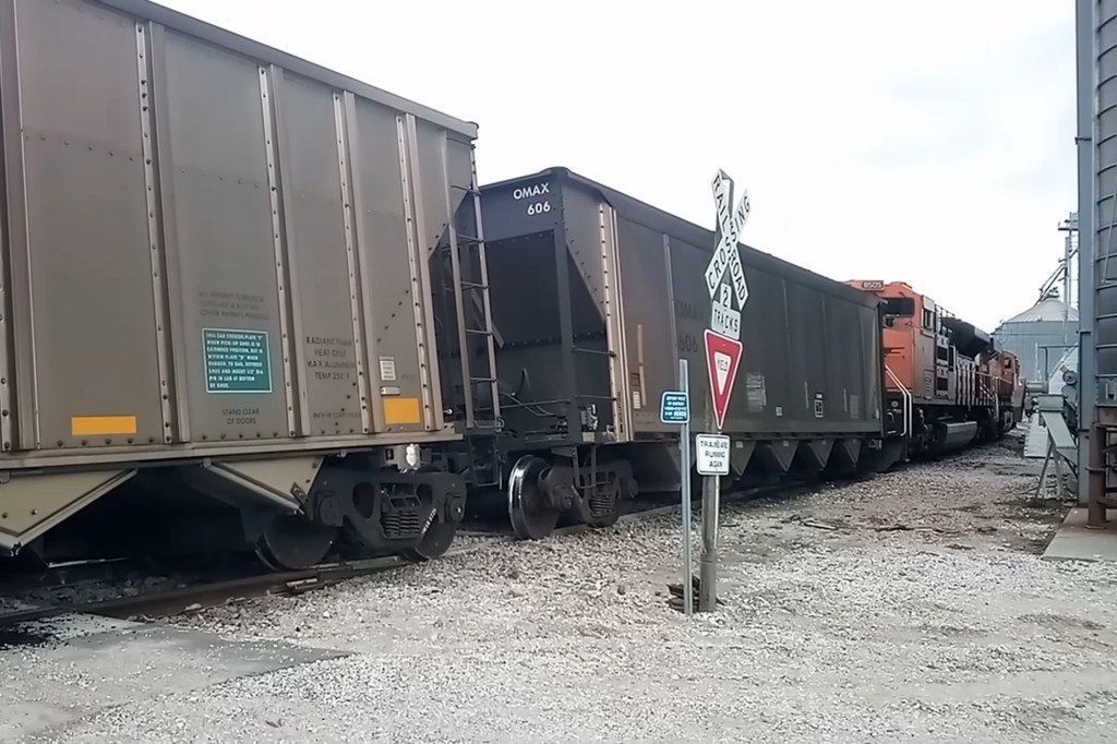 A derailed train sits slightly off the tracks