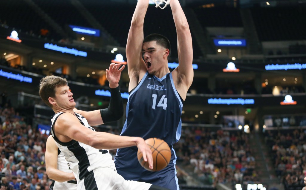 Zach Edey #14 of the Memphis Grizzlies reacts after he dunked the ball over Walker Kessler #24 of the Utah Jazz during the second half of their NBA Summer League game at the Delta Center on July 8, 2024 in Salt Lake City, Utah.